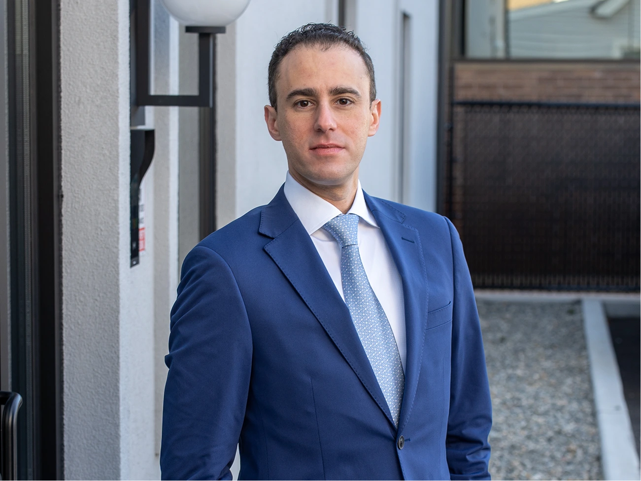 Dr. Daniel Bienstock in blue suit and tie, professional portrait in medical office