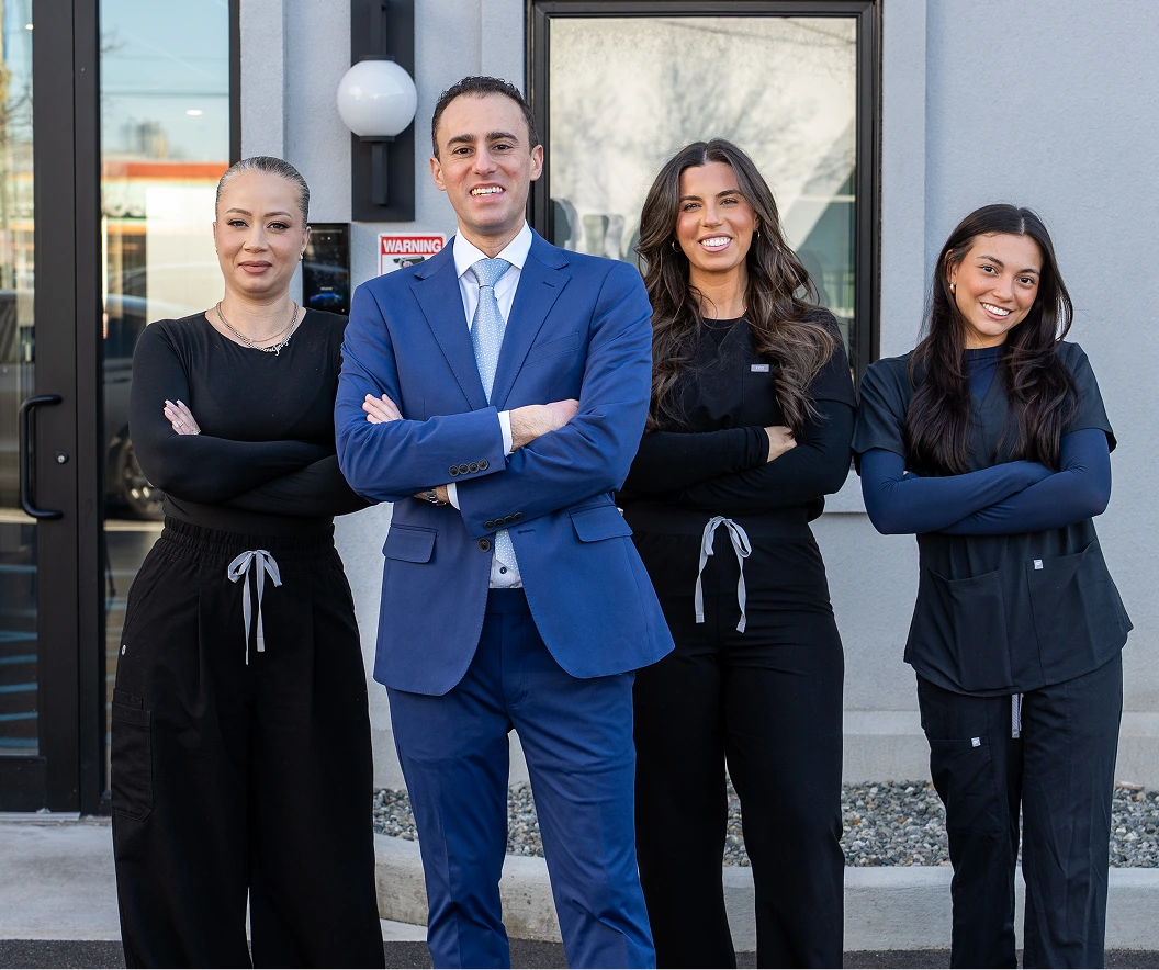 Dr. Daniel Bienstock and three team members standing outside the practice entrance
