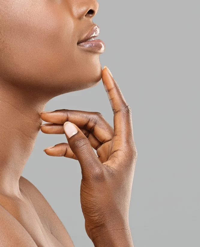 Woman in profile touching her lips with her hand