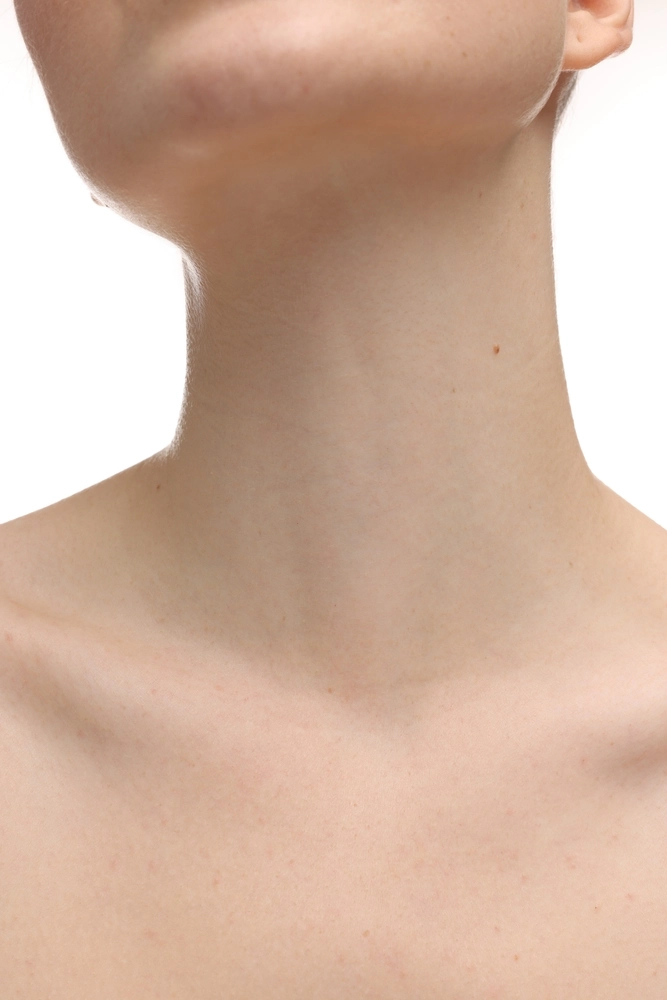 Back of person's neck and jawline against white background