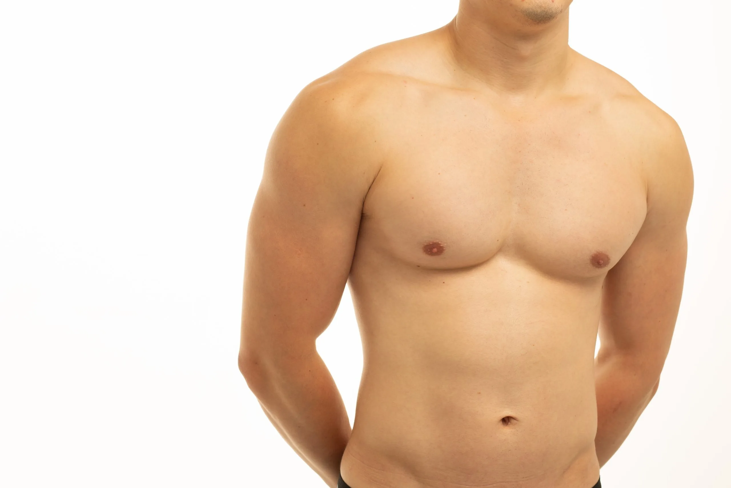 Shirtless man standing with arms at sides, frontal torso view