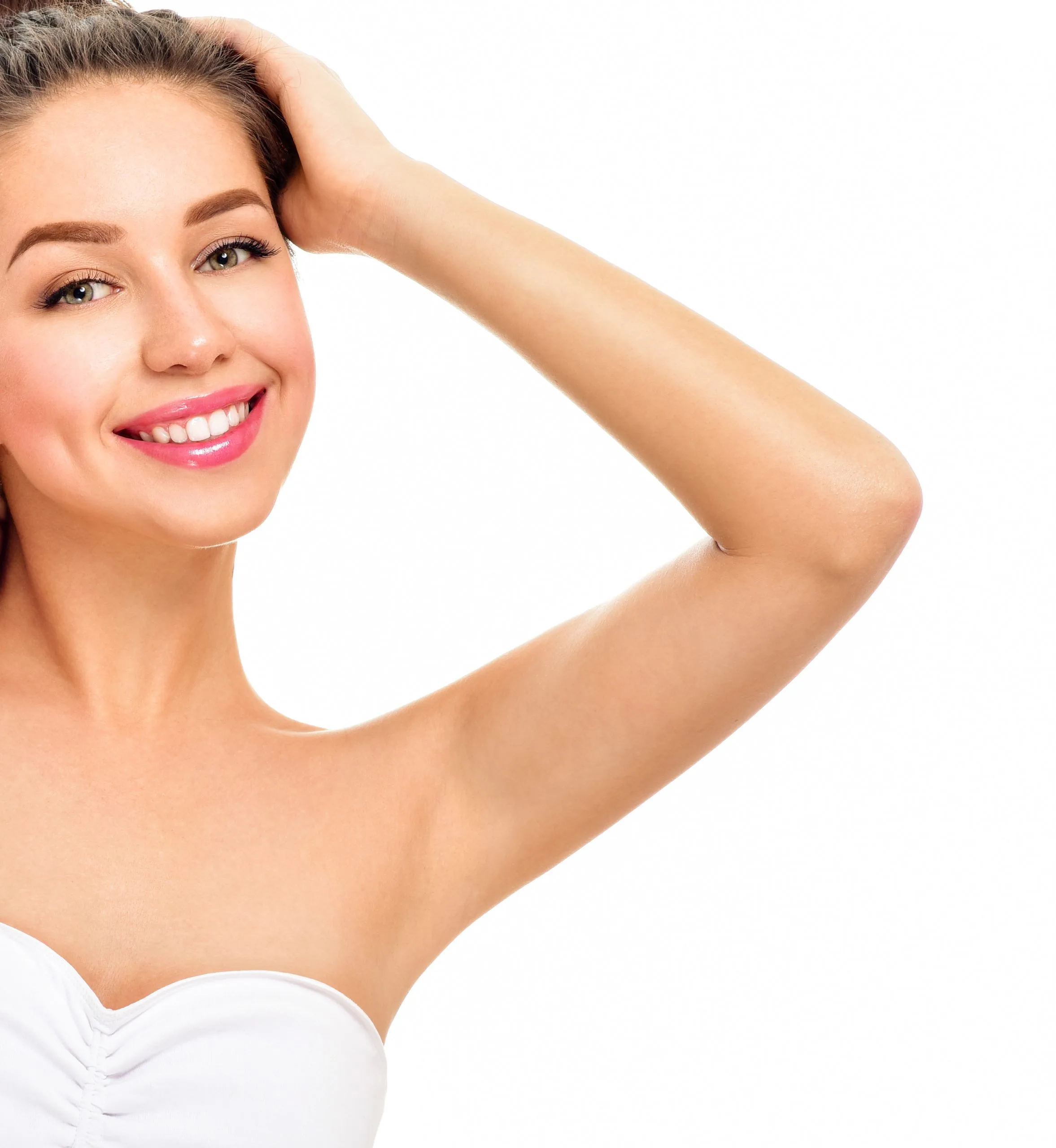 Smiling woman with hand raised to head showing clear skin