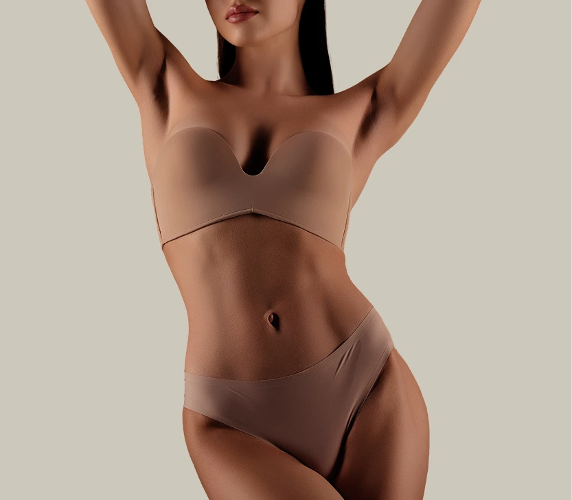 Woman demonstrating smooth, hair-free skin on arms and underarms